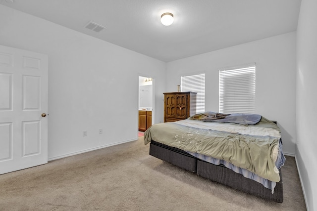 13013 Titanium St, Austin, TX 78754 - bedroom with carpet, connected bathroom, and baseboards