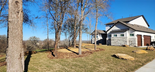 116 Merlin Ct, Cedar Creek, TX 78612 - view of side of property with a yard, board and batten siding, stone siding, and an attached garage