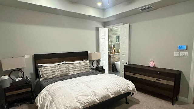 116 Merlin Ct, Cedar Creek, TX 78612 - bedroom with carpet floors, a raised ceiling, and ensuite bath
