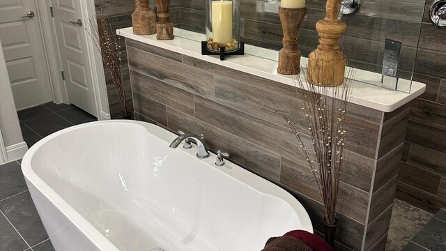 116 Merlin Ct, Cedar Creek, TX 78612 - full bathroom featuring a freestanding bath and tile patterned flooring