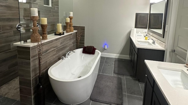 116 Merlin Ct, Cedar Creek, TX 78612 - bathroom with two vanities, tile patterned flooring, a walk in shower, and a freestanding bath