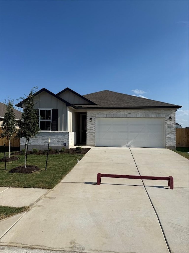 20509 Ed Townes Ter, Manor, TX 78653 - ranch-style home with driveway, a garage, and board and batten siding
