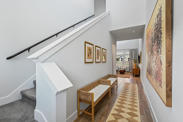 8513 Cottage Rose Dr, Austin, TX 78744 - corridor featuring stairway, wood finished floors, baseboards, and a high ceiling