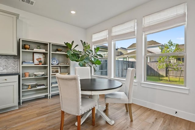 8513 Cottage Rose Dr, Austin, TX 78744 - dining space with light wood-type flooring, plenty of natural light, baseboards, and recessed lighting