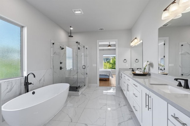 413 Mercer Falls Rd, Lakeway, TX 78738 - bathroom featuring a marble finish shower, double vanity, a freestanding tub, marble finish floors, and ceiling fan