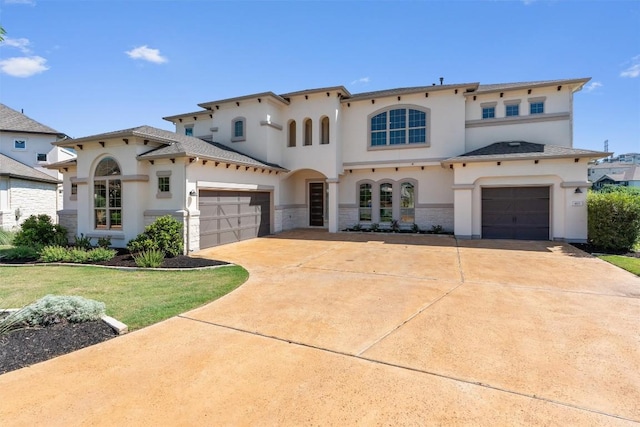 413 Mercer Falls Rd, Lakeway, TX 78738 - mediterranean / spanish-style home featuring stucco siding, driveway, stone siding, and an attached garage