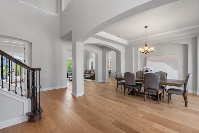 413 Mercer Falls Rd, Lakeway, TX 78738 - dining area with light wood-style flooring, healthy amount of natural light, a chandelier, and baseboards