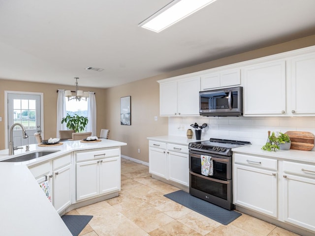 235 Herrera Trl, Hutto, TX 78634 - kitchen featuring stainless steel appliances, a sink, backsplash, light countertops, and a chandelier