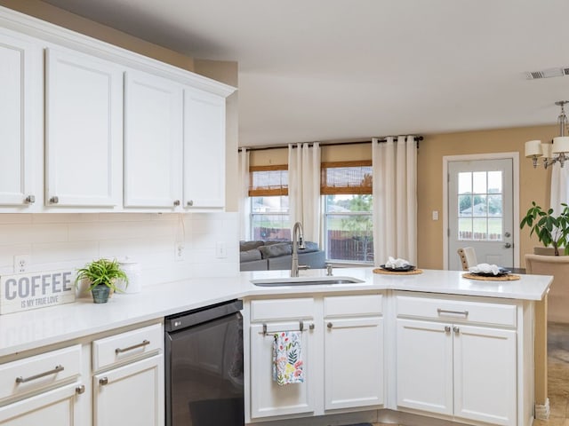 235 Herrera Trl, Hutto, TX 78634 - kitchen with a sink, dishwasher, a peninsula, white cabinetry, and tasteful backsplash
