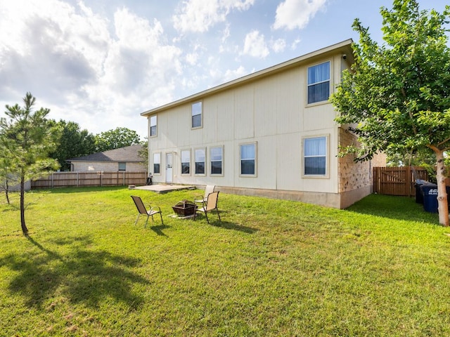 235 Herrera Trl, Hutto, TX 78634 - back of house with a fire pit