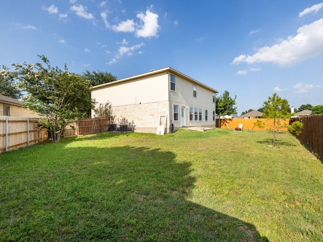 235 Herrera Trl, Hutto, TX 78634 - back of property with stone siding and cooling unit