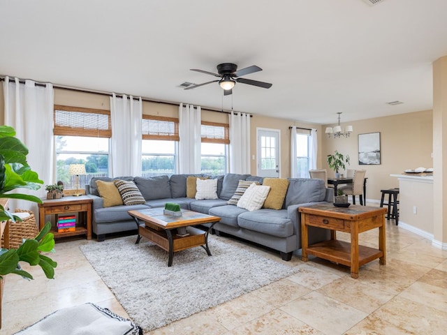 235 Herrera Trl, Hutto, TX 78634 - living room featuring ceiling fan, a chandelier, and baseboards