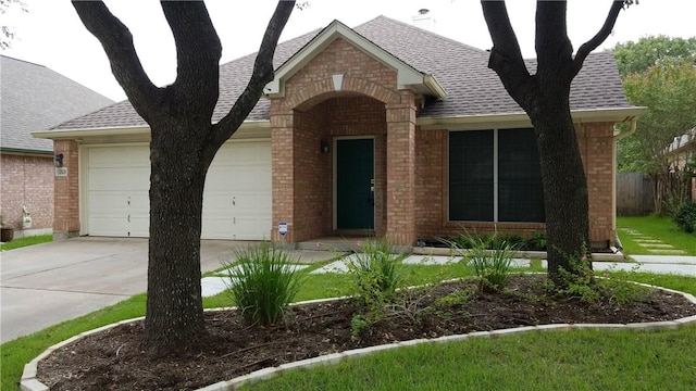 12828 Withers Way, Austin, TX 78727 - view of front of home with brick siding, a garage, roof with shingles, and driveway