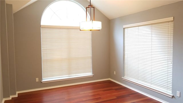 12828 Withers Way, Austin, TX 78727 - spare room featuring dark wood finished floors, healthy amount of natural light, baseboards, and lofted ceiling