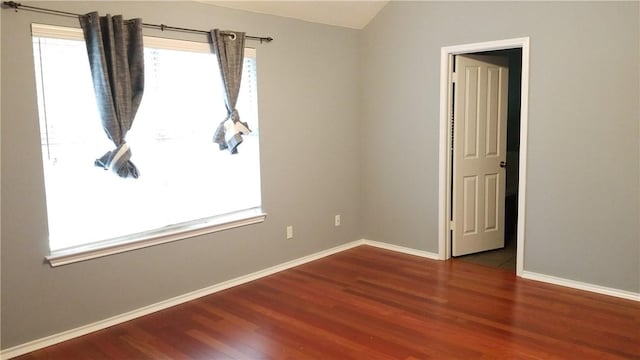 12828 Withers Way, Austin, TX 78727 - spare room featuring wood finished floors, baseboards, and lofted ceiling