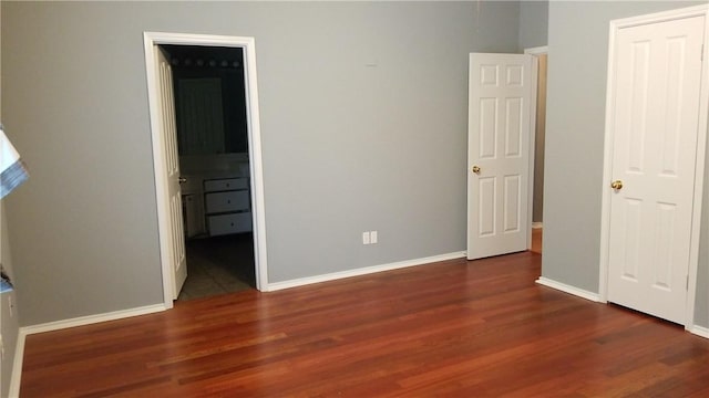 12828 Withers Way, Austin, TX 78727 - unfurnished bedroom featuring wood finished floors, baseboards, and ensuite bath