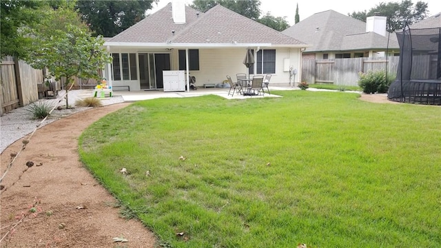 12828 Withers Way, Austin, TX 78727 - rear view of house featuring a trampoline, a patio, a sunroom, a shingled roof, and a chimney