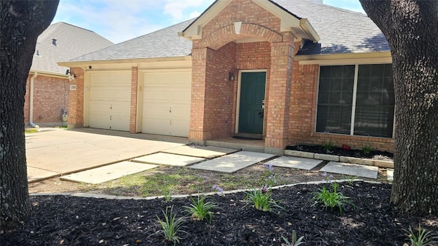12828 Withers Way, Austin, TX 78727 - view of front of property with brick siding, roof with shingles, and a garage