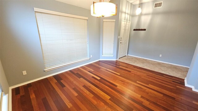 12828 Withers Way, Austin, TX 78727 - unfurnished room featuring wood finished floors and baseboards