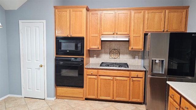 12828 Withers Way, Austin, TX 78727 - kitchen with black appliances, under cabinet range hood, tasteful backsplash, light tile patterned flooring, and brown cabinets