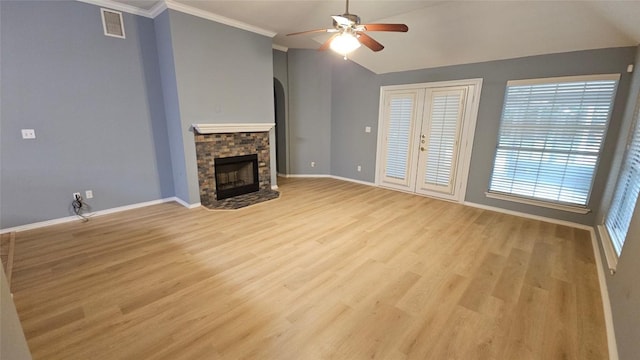 12828 Withers Way, Austin, TX 78727 - unfurnished living room featuring a ceiling fan, a fireplace, light wood finished floors, arched walkways, and crown molding