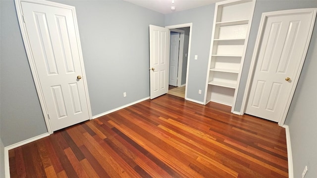 12828 Withers Way, Austin, TX 78727 - unfurnished bedroom featuring dark wood-style flooring and baseboards