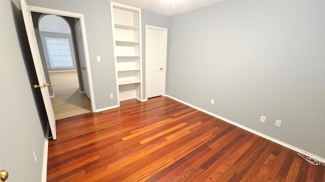 12828 Withers Way, Austin, TX 78727 - unfurnished bedroom featuring baseboards and wood finished floors