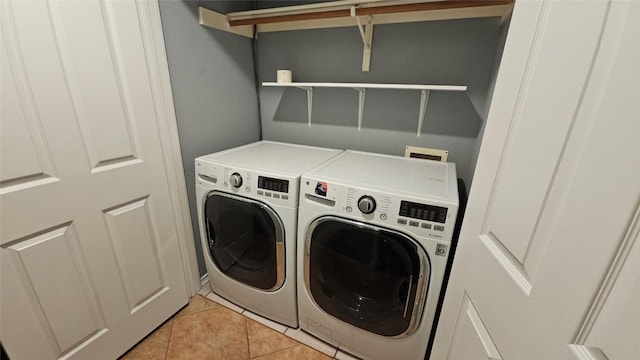 12828 Withers Way, Austin, TX 78727 - washroom featuring washer and clothes dryer and light tile patterned floors