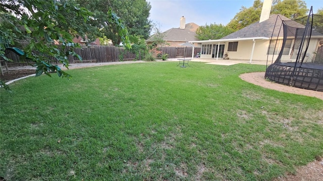 12828 Withers Way, Austin, TX 78727 - fenced backyard with a trampoline and a patio area