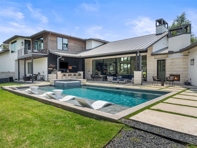 6037 Verandero Ct, Austin, TX 78738 - back of property featuring outdoor lounge area, a standing seam roof, a balcony, and a patio area