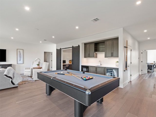 6037 Verandero Ct, Austin, TX 78738 - recreation room with bar with sink, billiards table, recessed lighting, light wood finished floors, and beverage cooler