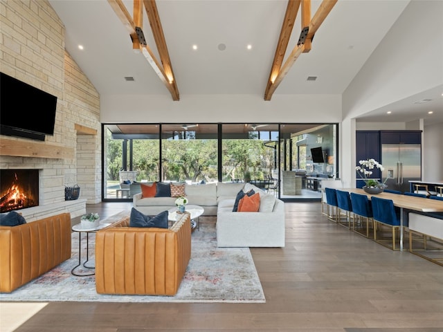 6037 Verandero Ct, Austin, TX 78738 - living room featuring a stone fireplace, high vaulted ceiling, healthy amount of natural light, beamed ceiling, and wood finished floors