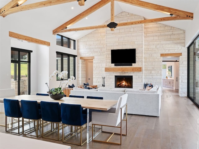 6037 Verandero Ct, Austin, TX 78738 - dining area featuring high vaulted ceiling, beam ceiling, a stone fireplace, healthy amount of natural light, and wood finished floors