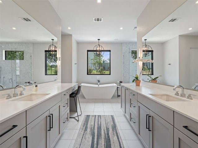 6037 Verandero Ct, Austin, TX 78738 - bathroom featuring a chandelier, two vanities, a stall shower, a freestanding bath, and recessed lighting
