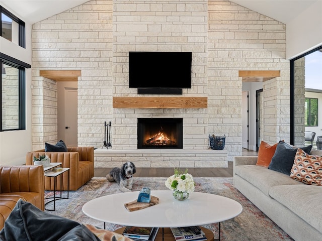 6037 Verandero Ct, Austin, TX 78738 - living area featuring lofted ceiling, a stone fireplace, and wood finished floors