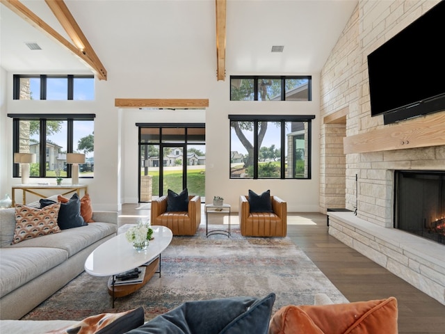 6037 Verandero Ct, Austin, TX 78738 - living area featuring wood finished floors, beam ceiling, a fireplace, high vaulted ceiling, and baseboards
