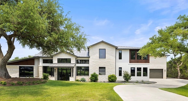 6037 Verandero Ct, Austin, TX 78738 - view of front of property with a standing seam roof, stone siding, concrete driveway, a metal roof, and a front yard
