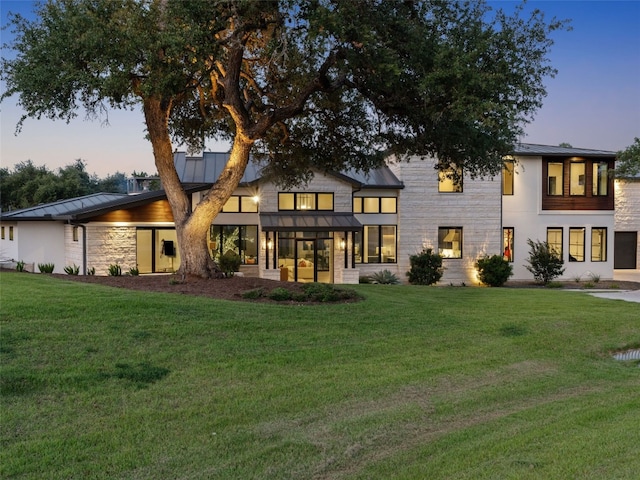 6037 Verandero Ct, Austin, TX 78738 - back of property featuring a standing seam roof, a yard, and a metal roof