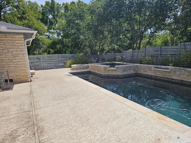 1407 Wilshire Blvd, Austin, TX 78722 - view of pool with a fenced backyard, an in-ground hot tub, and a patio