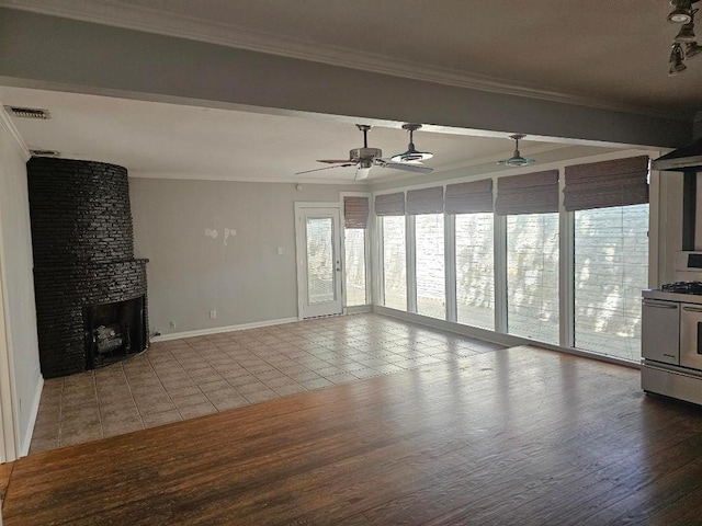 1407 Wilshire Blvd, Austin, TX 78722 - unfurnished living room featuring crown molding, ceiling fan, tile patterned floors, a large fireplace, and baseboards