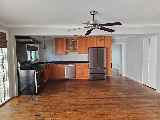 1407 Wilshire Blvd, Austin, TX 78722 - kitchen with appliances with stainless steel finishes, dark countertops, ceiling fan, dark wood finished floors, and crown molding