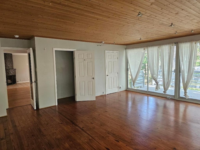 1407 Wilshire Blvd, Austin, TX 78722 - unfurnished room with crown molding, dark wood-style floors, wooden ceiling, baseboards, and a fireplace