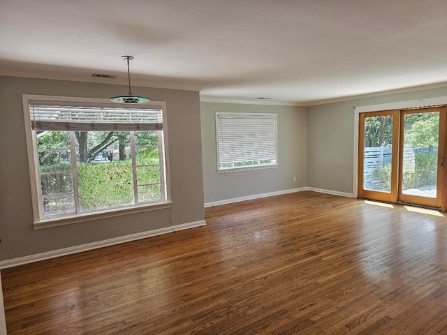1407 Wilshire Blvd, Austin, TX 78722 - spare room with ornamental molding, healthy amount of natural light, wood-type flooring, and baseboards
