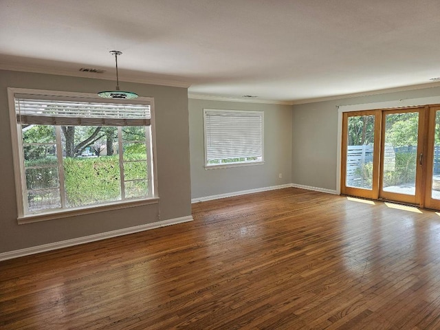 1407 Wilshire Blvd, Austin, TX 78722 - spare room featuring crown molding, wood-type flooring, and baseboards