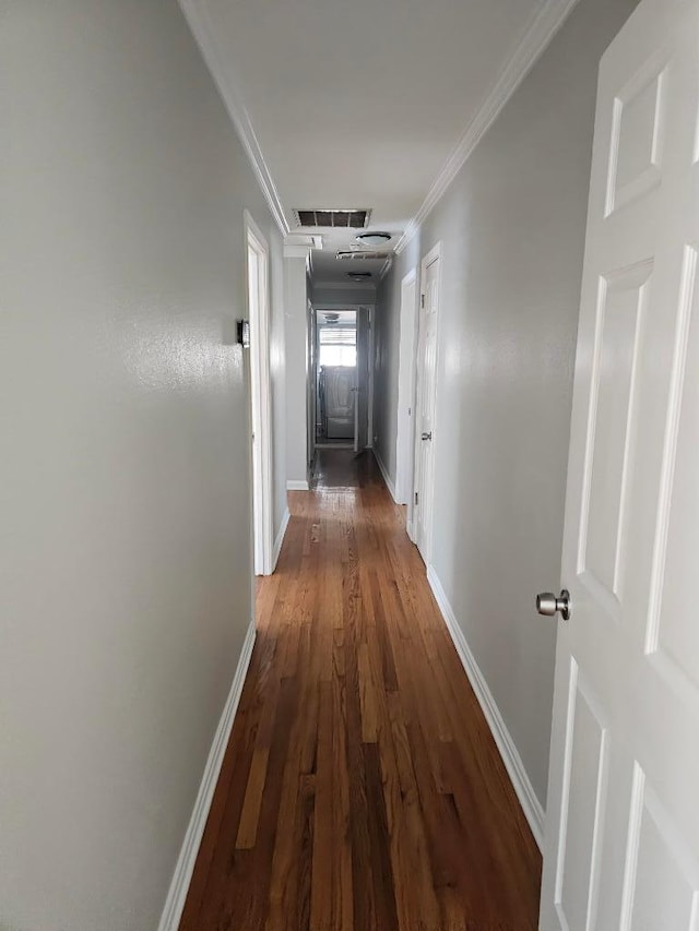 1407 Wilshire Blvd, Austin, TX 78722 - hallway featuring crown molding, baseboards, wood finished floors, and attic access