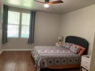 387 Mcgarity, Kyle, TX 78640 - bedroom with dark wood-style floors, baseboards, and a ceiling fan