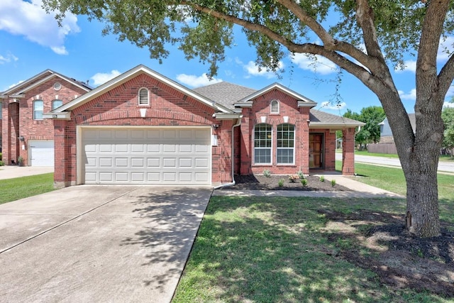 2801 Stirrup Cv, Leander, TX 78641 - traditional-style home with brick siding, driveway, an attached garage, and a front yard