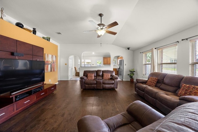 2801 Stirrup Cv, Leander, TX 78641 - living area featuring arched walkways, ceiling fan, lofted ceiling, dark wood-type flooring, and baseboards