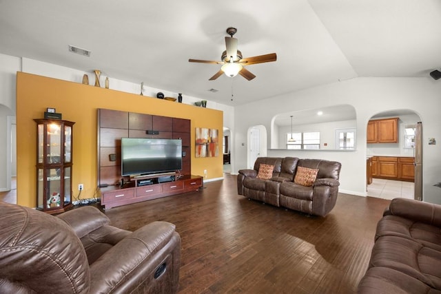 2801 Stirrup Cv, Leander, TX 78641 - living area featuring arched walkways, a ceiling fan, wood finished floors, vaulted ceiling, and baseboards