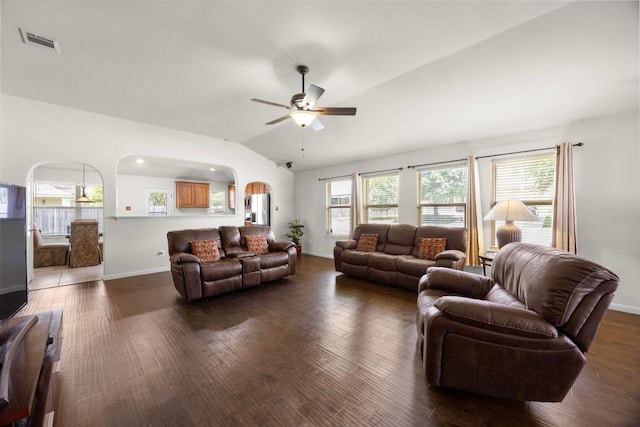2801 Stirrup Cv, Leander, TX 78641 - living room with vaulted ceiling, a ceiling fan, dark wood-style flooring, baseboards, and arched walkways